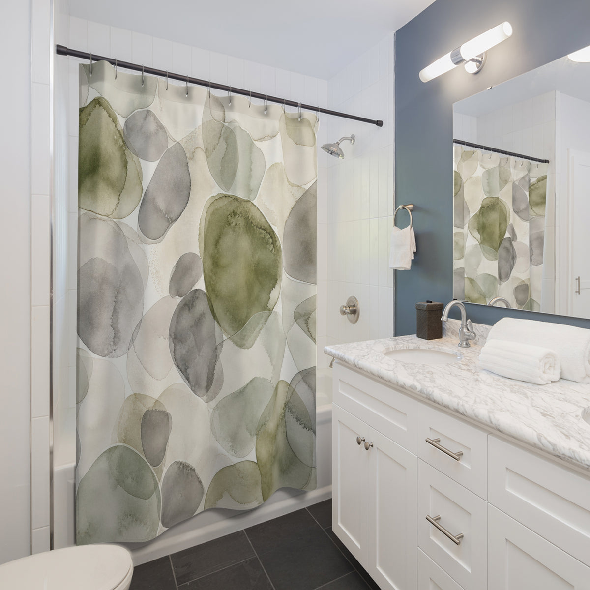 Green Grey Watercolor Circle abstract shower curtain beside a white vanity