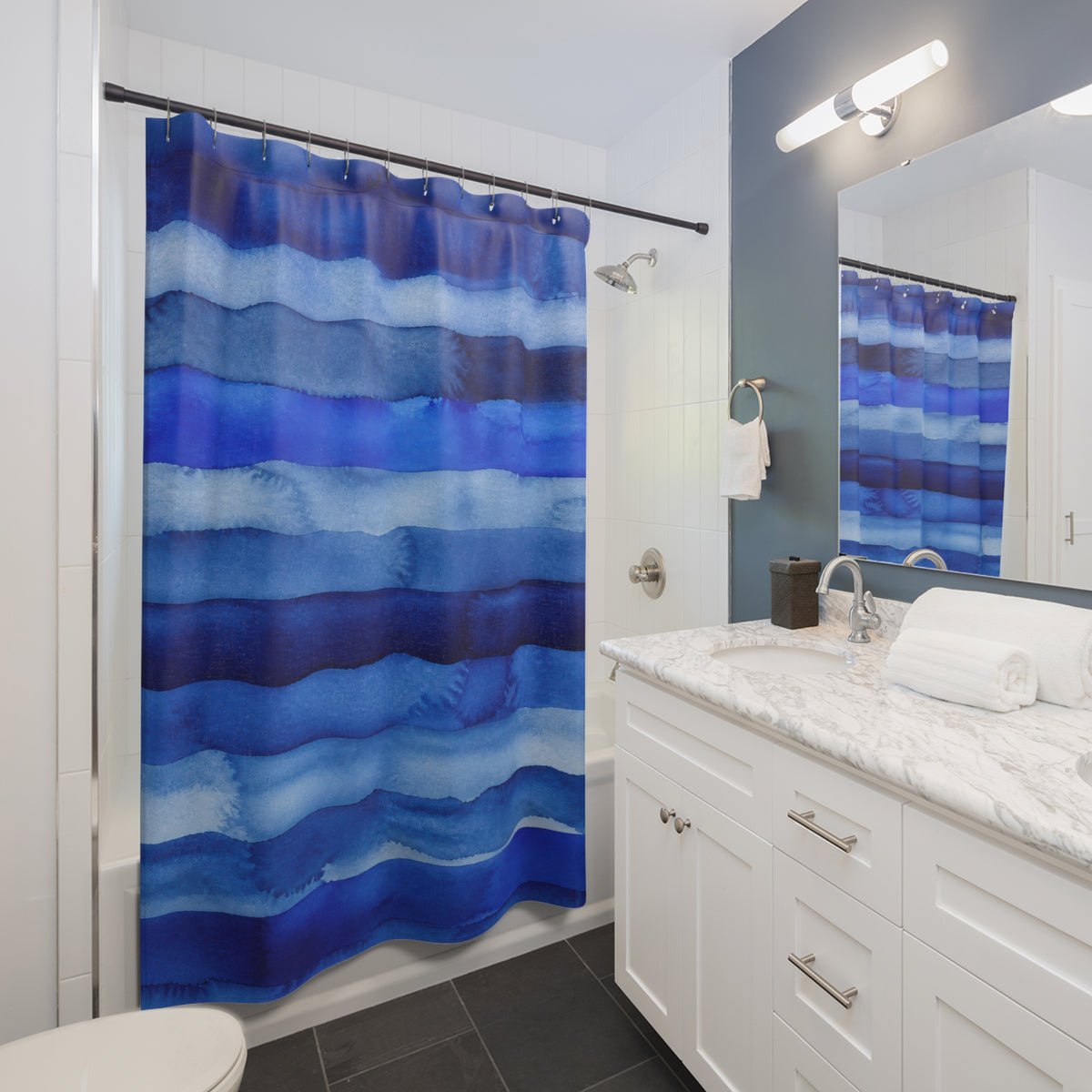 Cobalt Navy Horizontal Stripe watercolor shower curtain beside a white vanity