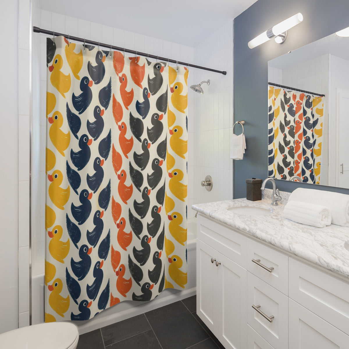 Rubber ducks in yellow orange navy and charcoal rows shower curtain beside a white vanity