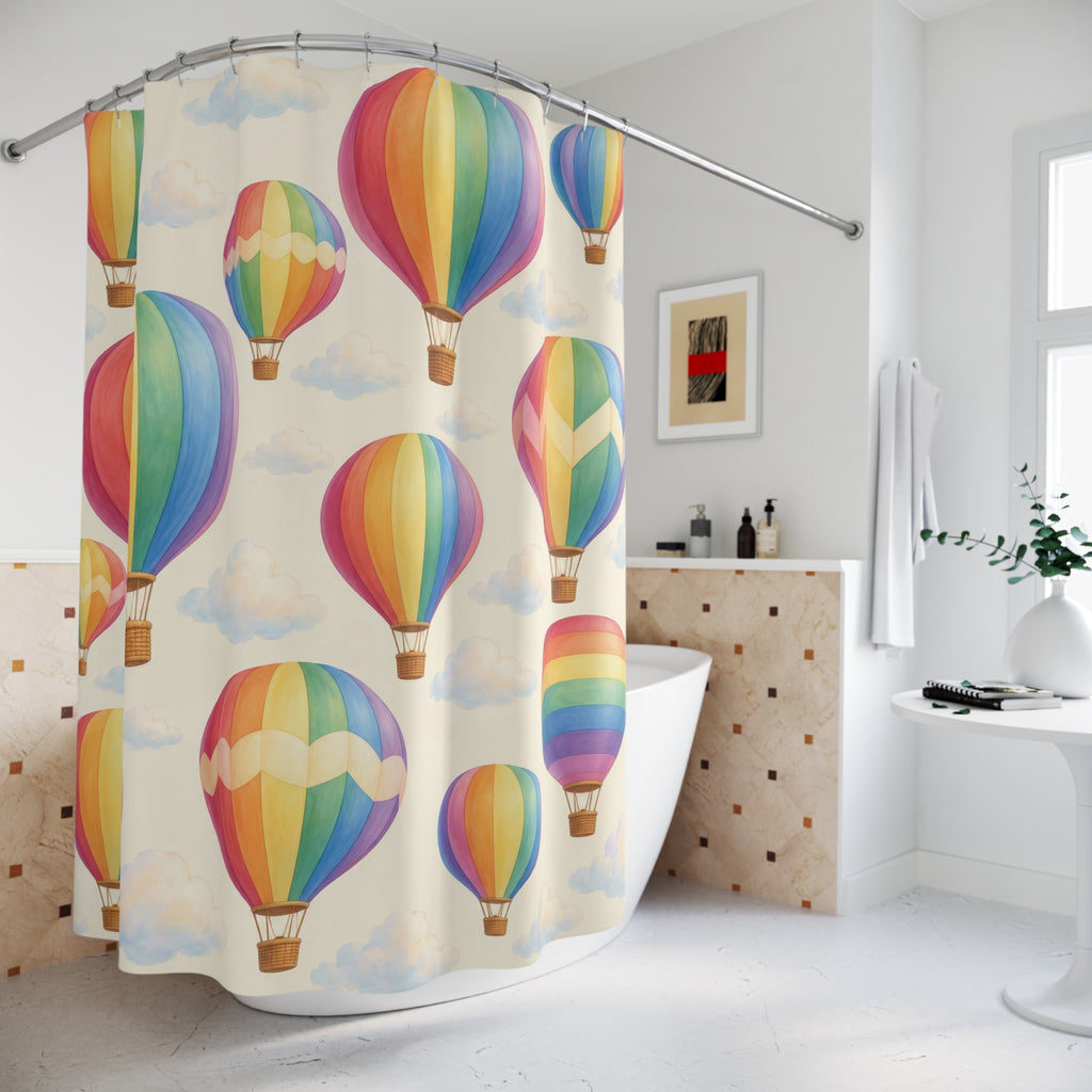 Pastel rainbow hot air balloons and clouds on cream shower curtain beside a freestanding tub