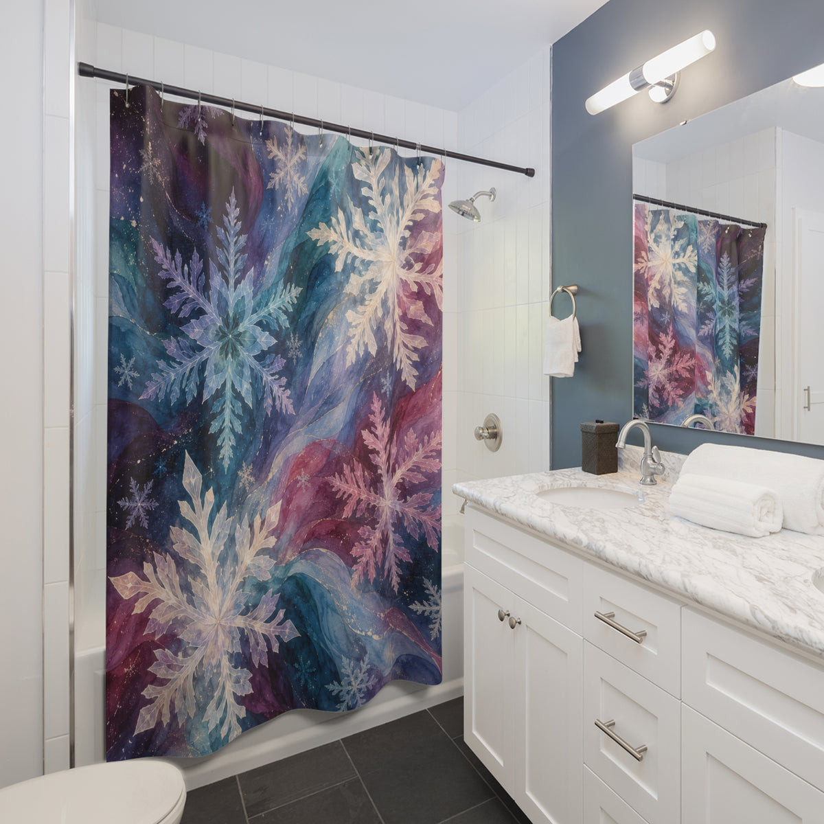 Pastel snowflakes over teal, plum, and pink watercolor currents shower curtain beside a white vanity