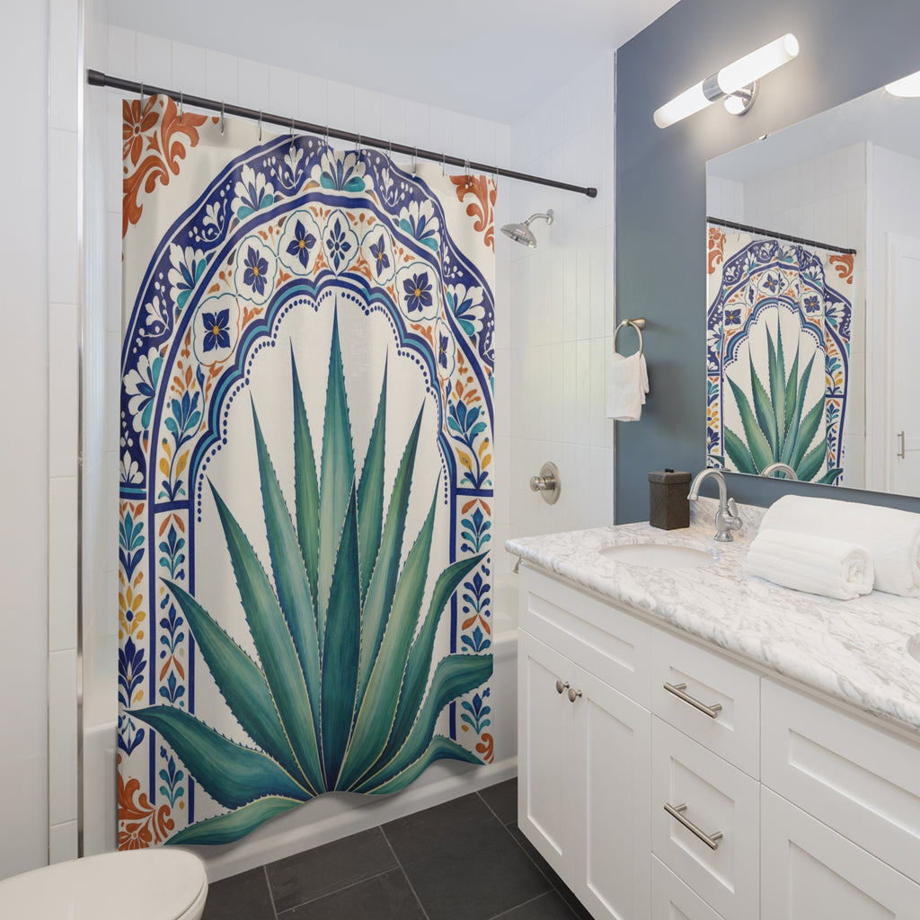Green agave in a cobalt ornamental arch shower curtain beside a white vanity