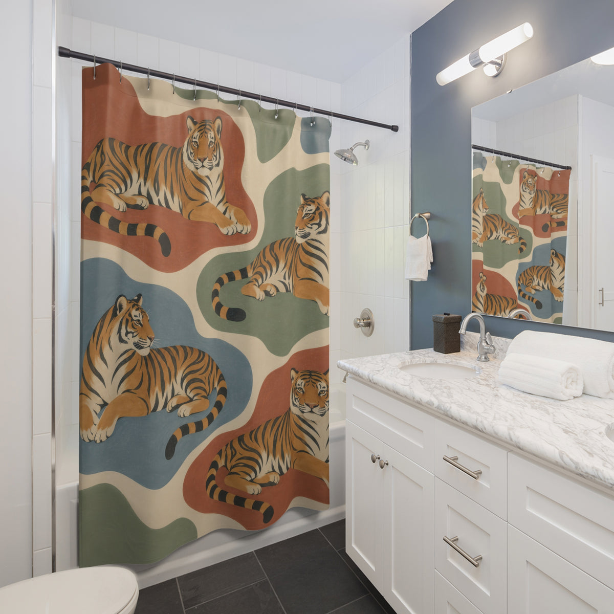 Ochre tigers on terracotta sage and dusty-blue shapes shower curtain beside a white vanity