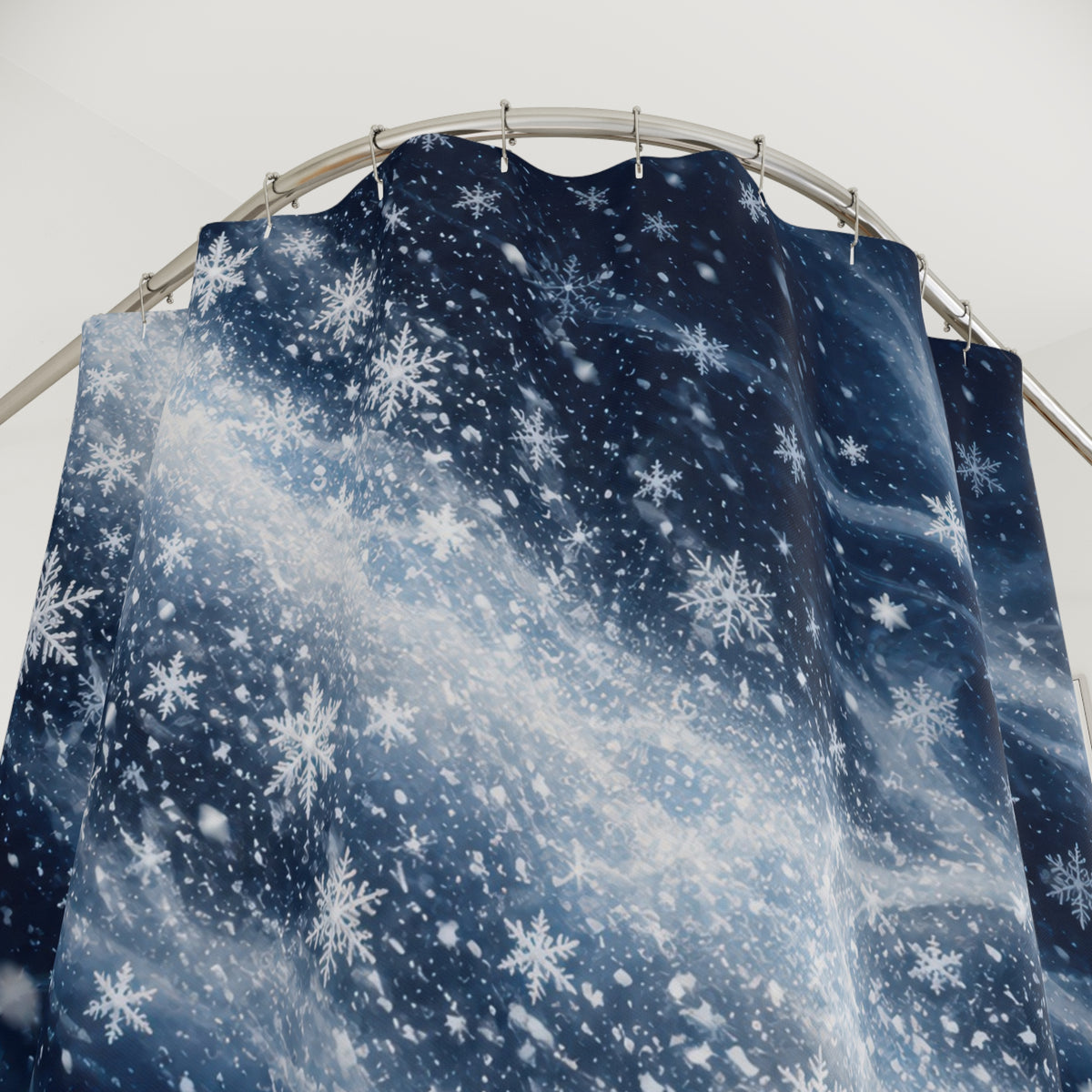 Navy swirling snowfall shower curtain with close-up print, hooks, and folds
