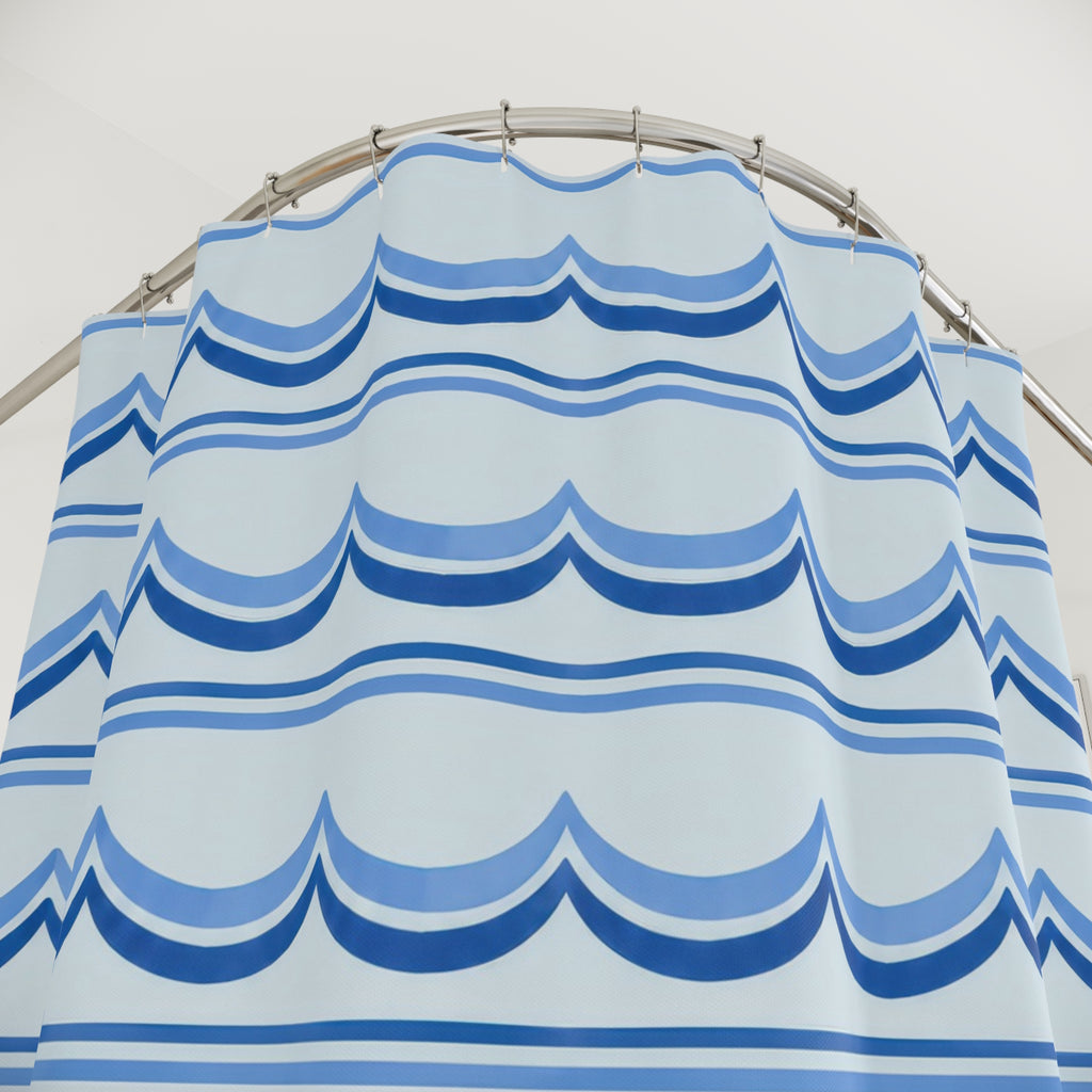 Cornflower and cobalt scallop bands on pale blue shower curtain with close-up print, hooks, and folds