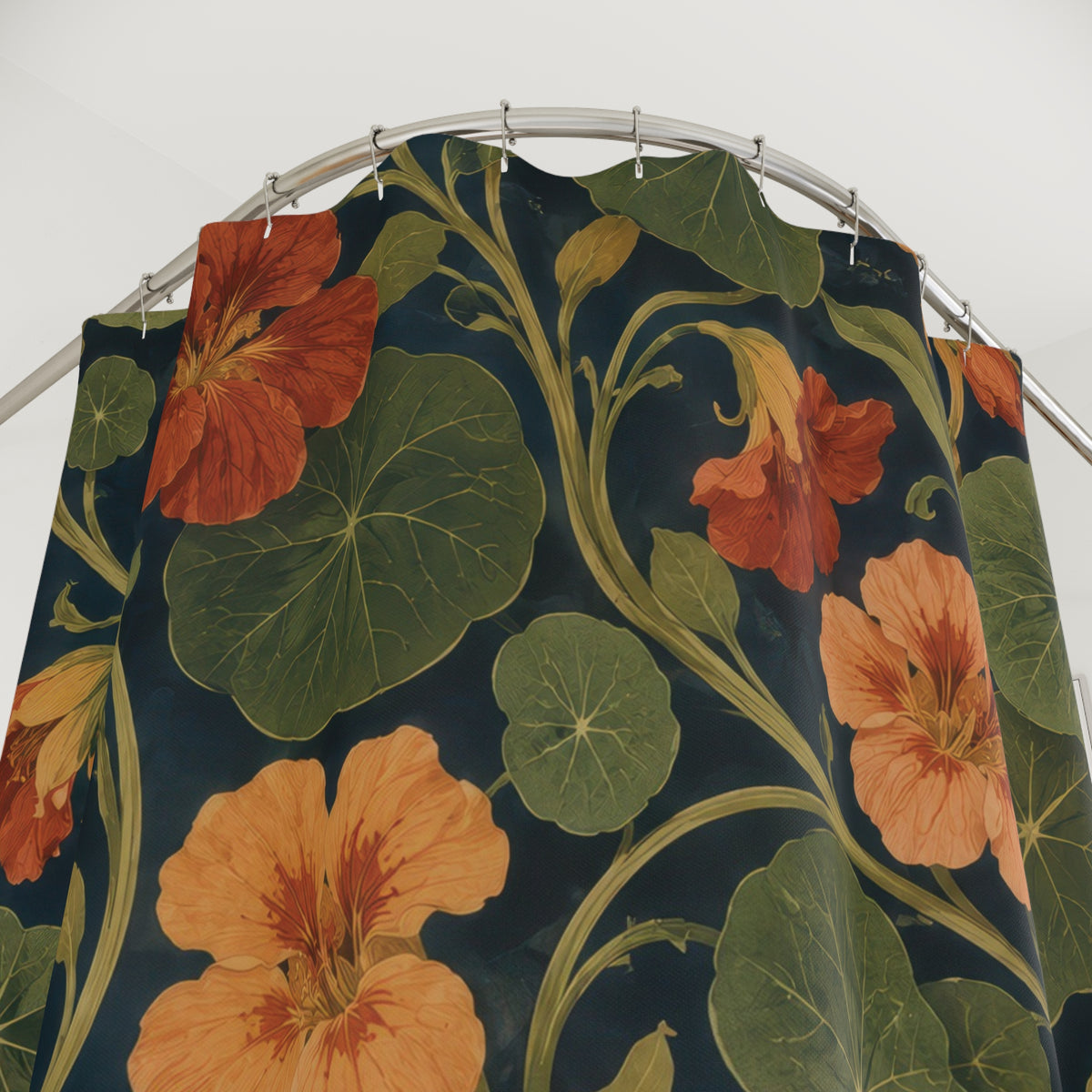 Rust nasturtiums and olive leaves on navy shower curtain with close-up print, hooks, and folds
