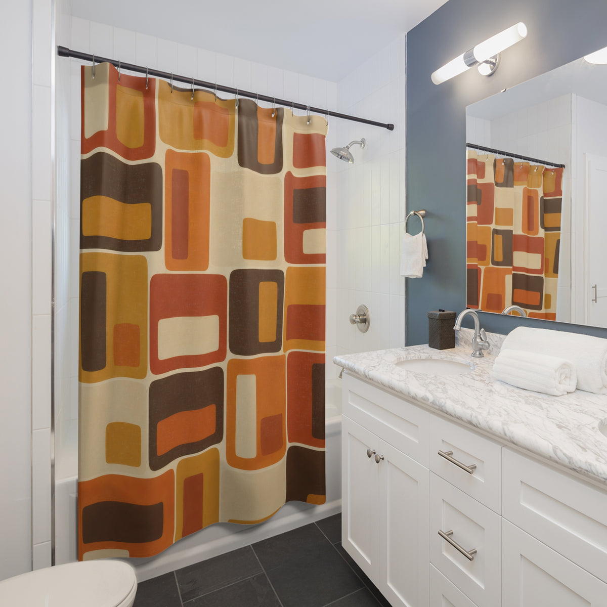 Orange, amber and brown nested rectangles with cream spaces shower curtain beside a white vanity