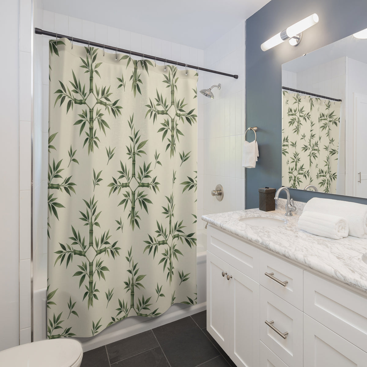 Sage bamboo ornaments and leaf sprigs on cream shower curtain beside a white vanity