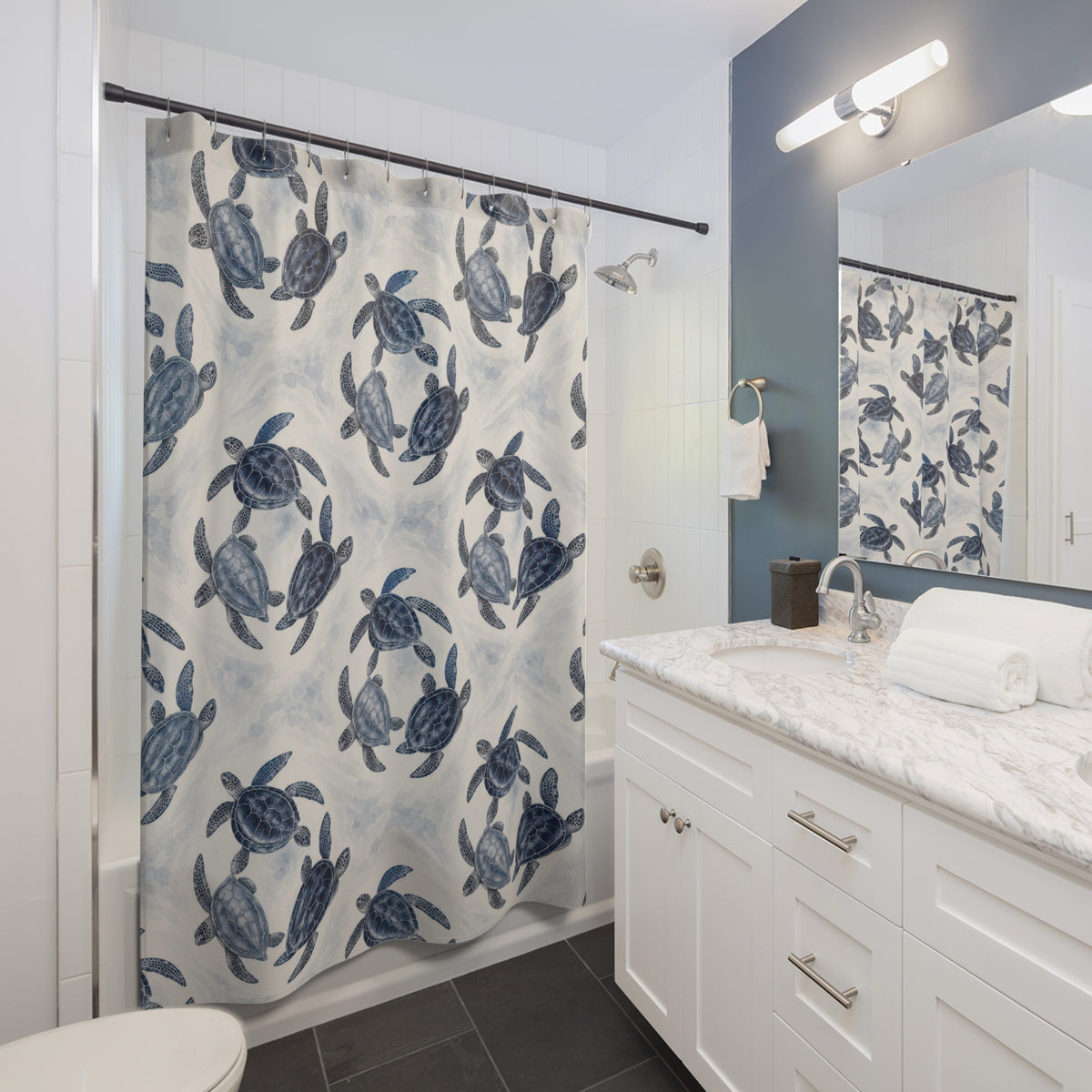 Navy and slate-blue sea turtle trios shower curtain beside a white vanity