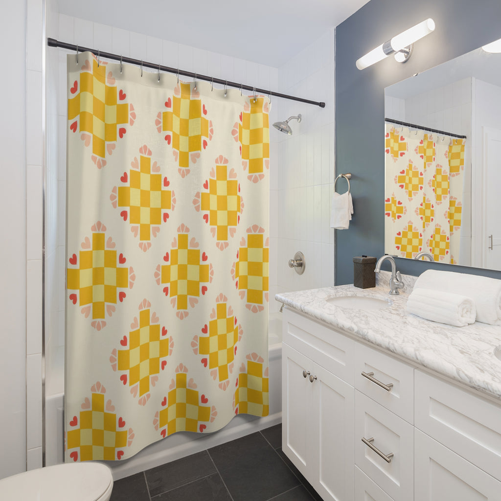 Yellow checker medallions with coral hearts shower curtain beside a white vanity