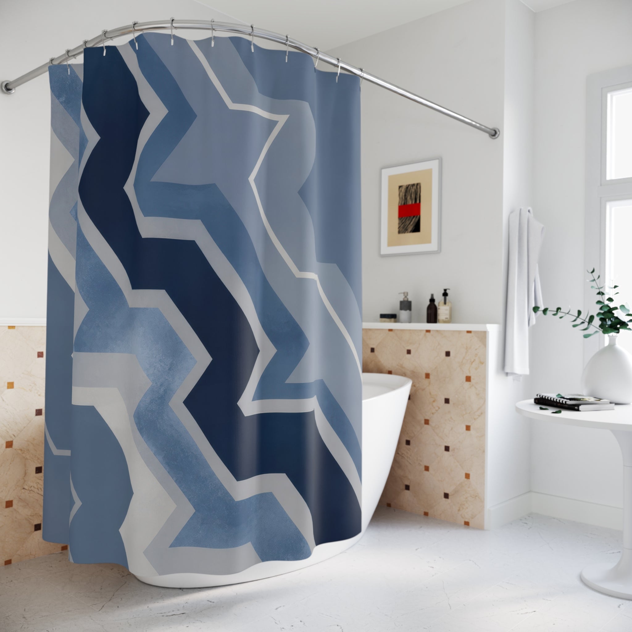 Blue and grey offset zigzag chevrons cascading diagonally shower curtain beside a freestanding tub