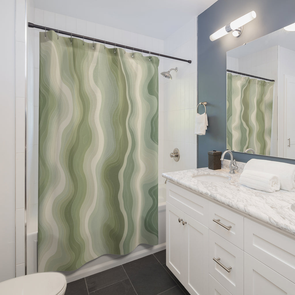 Sage green organic contour line pattern on an ivory ground shower curtain beside a white vanity