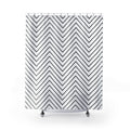 Thin black chevron zigzags on an open white ground shower curtain with full front view