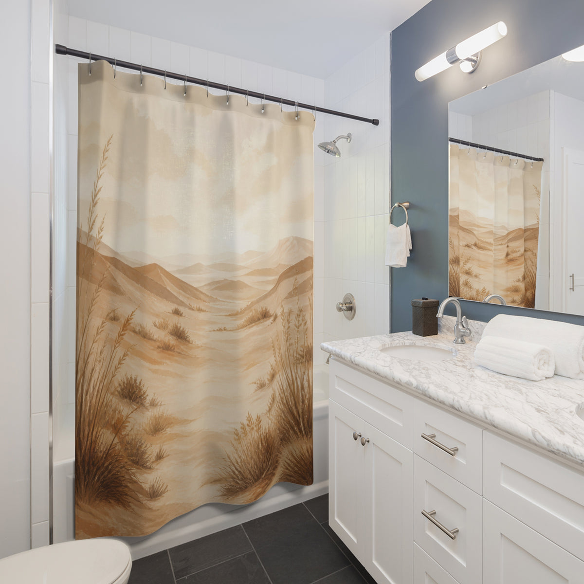 Sweeping tan dunes and wind-shaped grasses beneath a hazy horizon shower curtain beside a white vanity