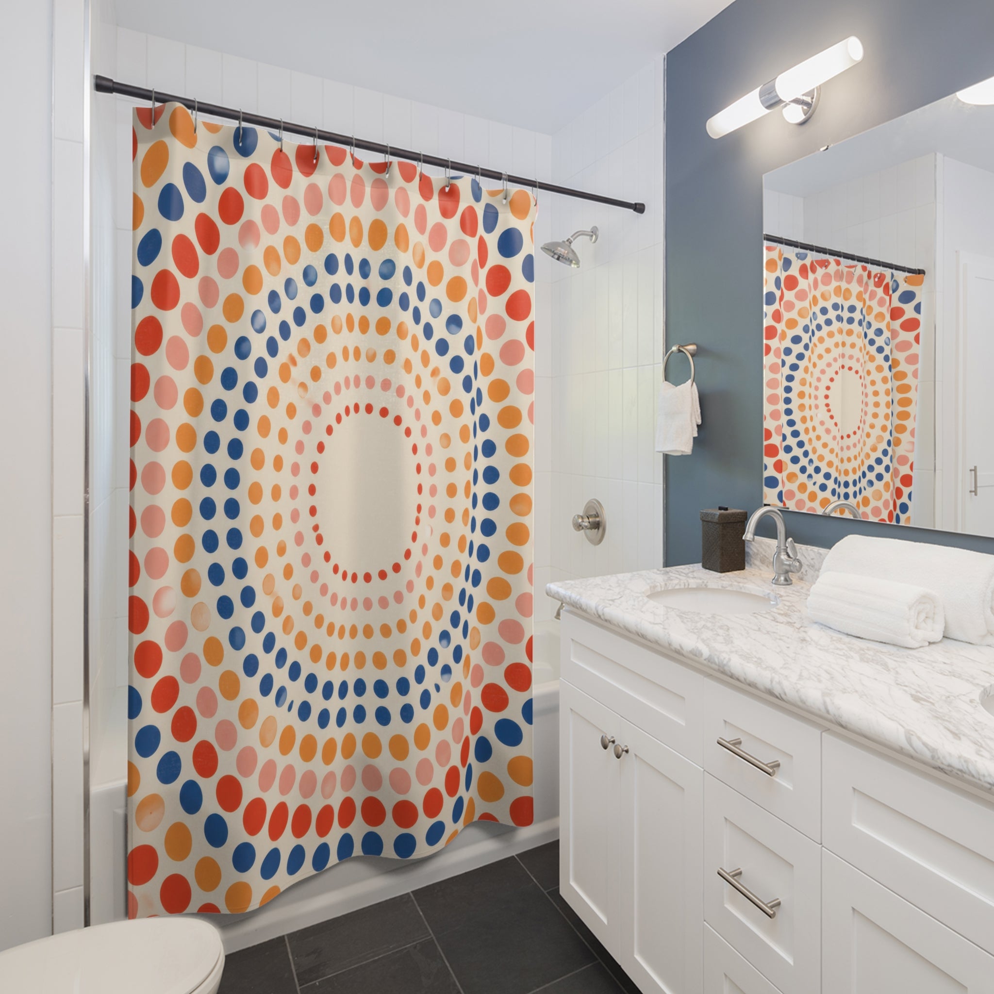 Coral and navy concentric polka dots shower curtain beside a white vanity