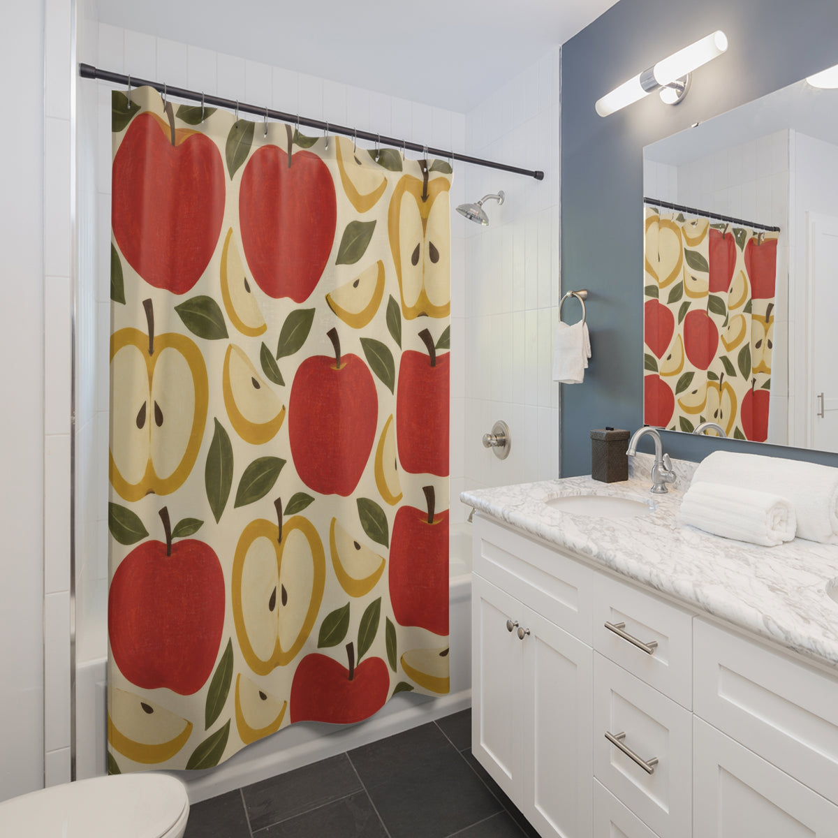 Red apples and yellow apple halves with olive leaves shower curtain beside a white vanity