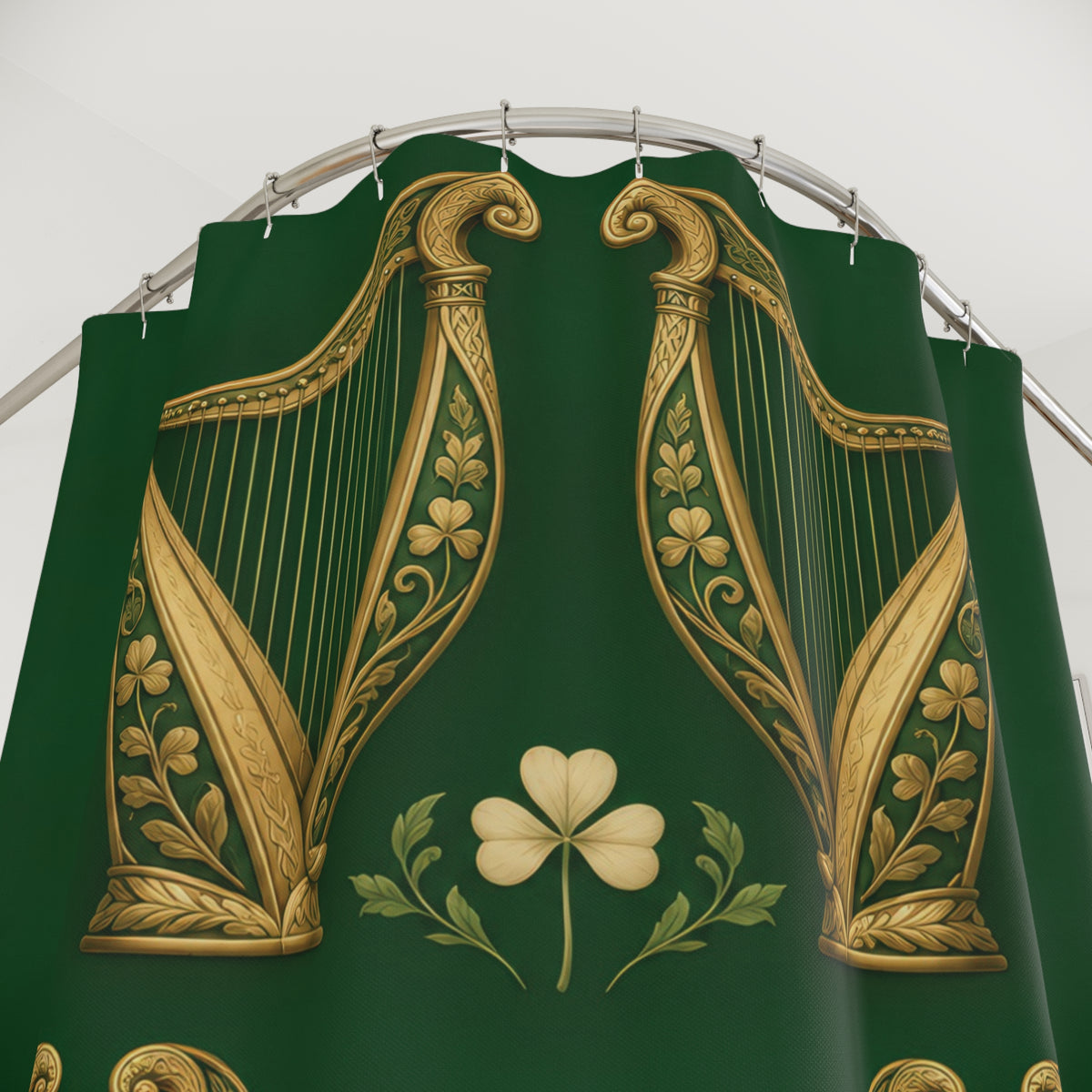 Gold-tone Irish harps and cream shamrocks on green shower curtain with close-up print, hooks, and folds
