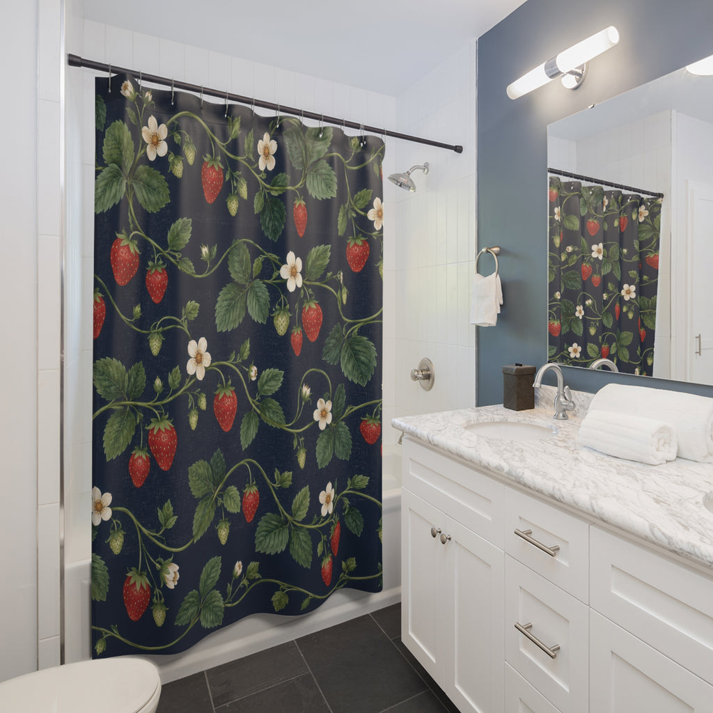 Red strawberries and ivory flowers on navy shower curtain beside a white vanity