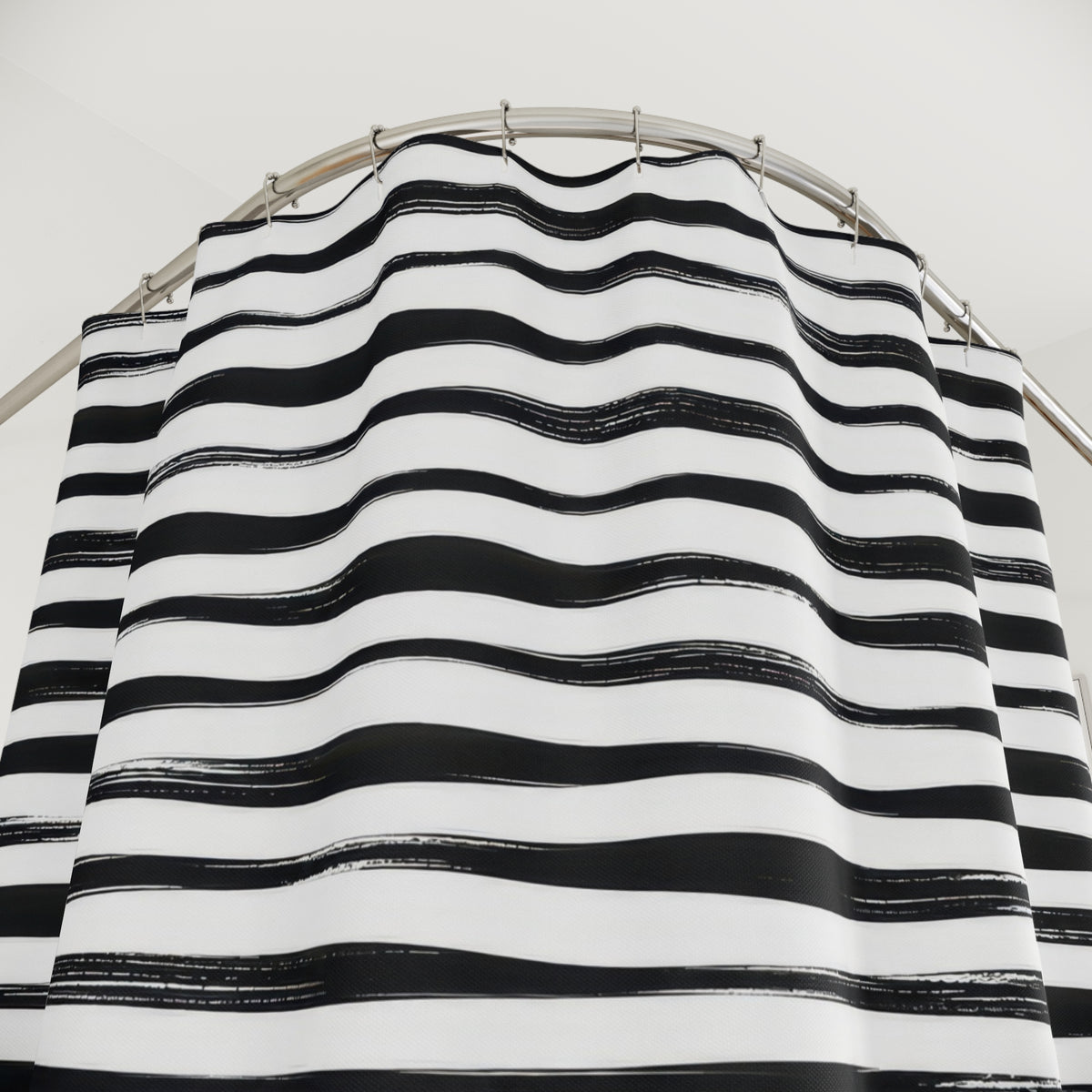 Horizontal black brush stripes with white dry-ink streaks shower curtain with close-up print, hooks, and folds