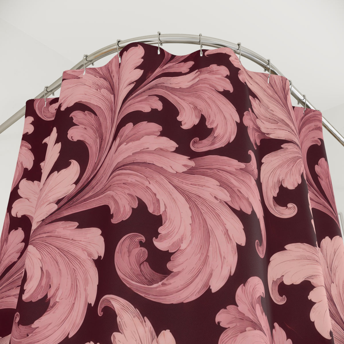 Blush acanthus leaves on deep burgundy shower curtain with close-up print, hooks, and folds