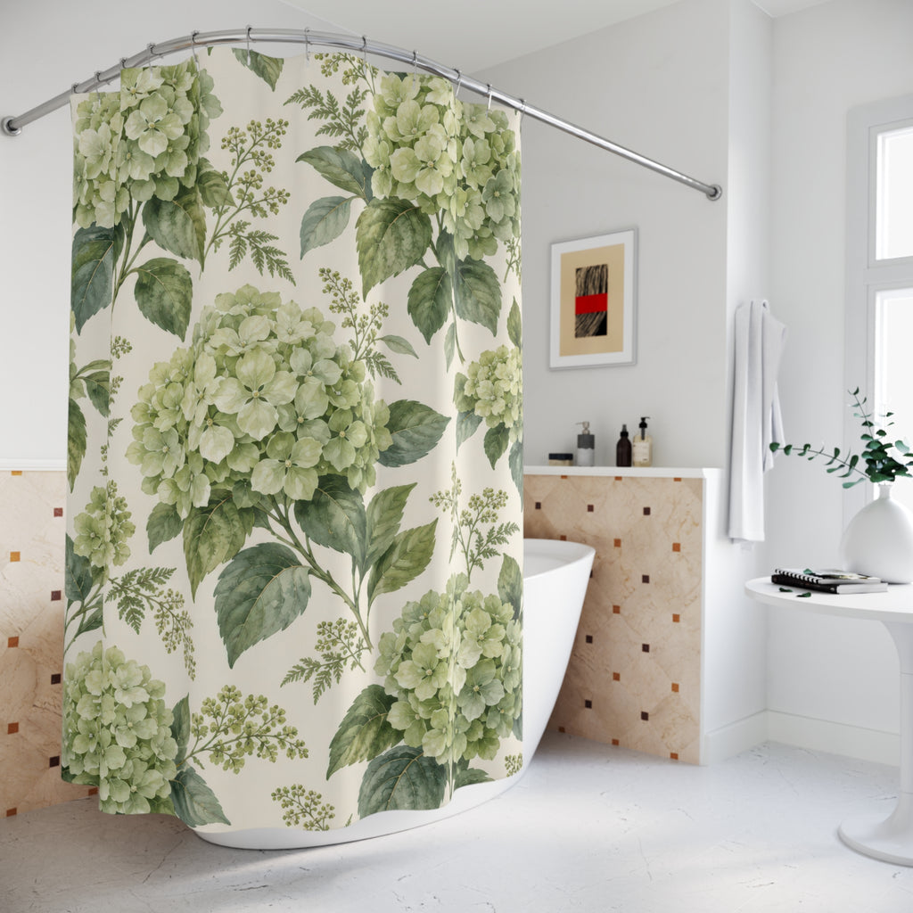 Sage-green hydrangea clusters and leaves on warm cream shower curtain beside a freestanding tub