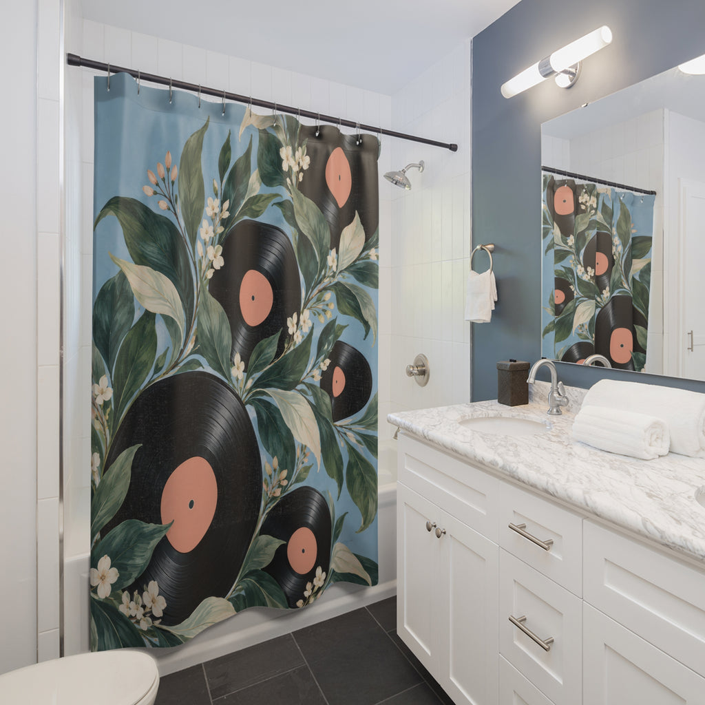 Black vinyl records with green leaves and cream blossoms shower curtain beside a white vanity