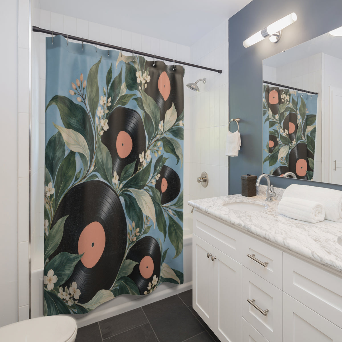 Black vinyl records with green leaves and cream blossoms shower curtain beside a white vanity
