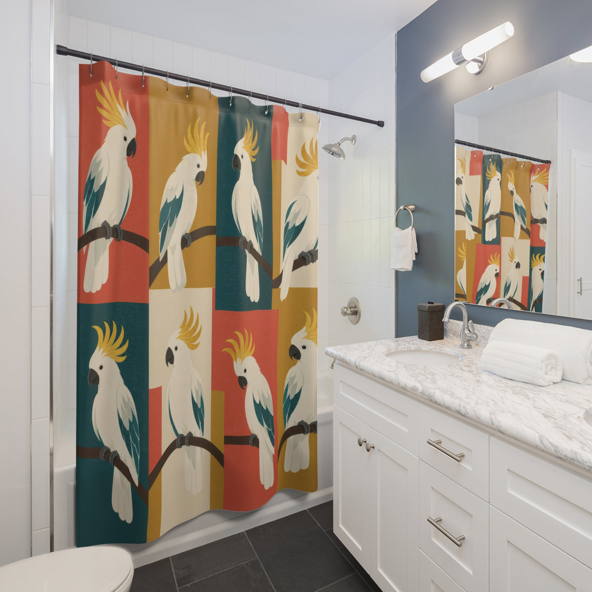 Cream cockatoos on coral, teal and ochre color blocks shower curtain beside a white vanity