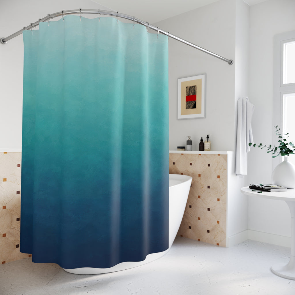 Aqua to deep blue ombre with teal midtones shower curtain beside a freestanding tub