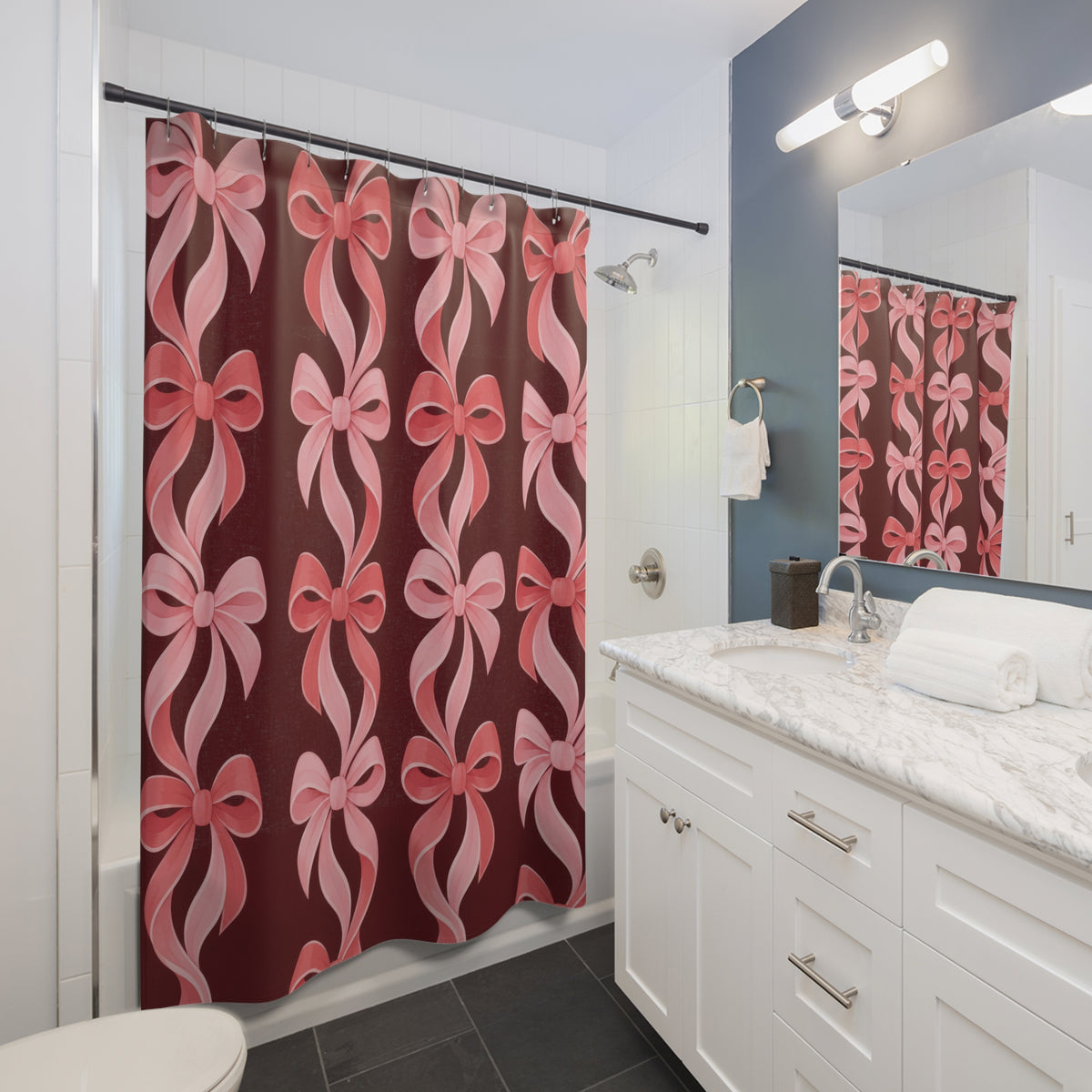 Pink bow chains in blush and coral on burgundy shower curtain beside a white vanity