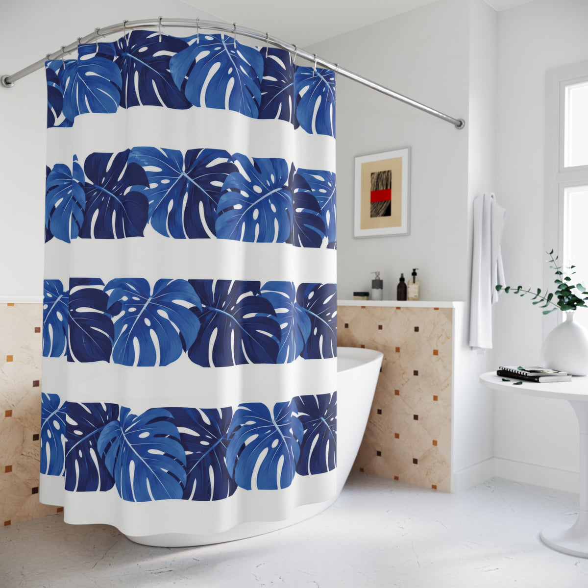 Cobalt monstera leaf bands alternating with white stripes shower curtain beside a freestanding tub