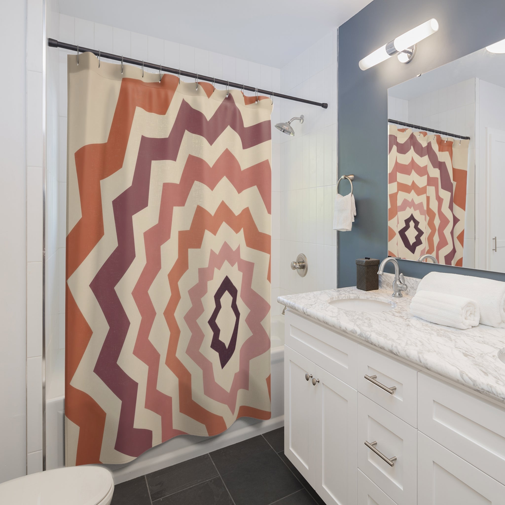 Terracotta and plum nested zigzag diamond ripples shower curtain beside a white vanity