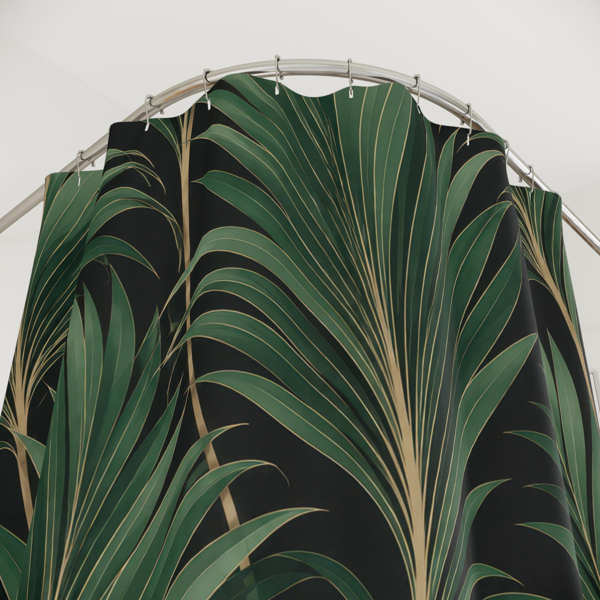 Jade palm fans with fine gold-tone lines on black shower curtain with close-up print, hooks, and folds