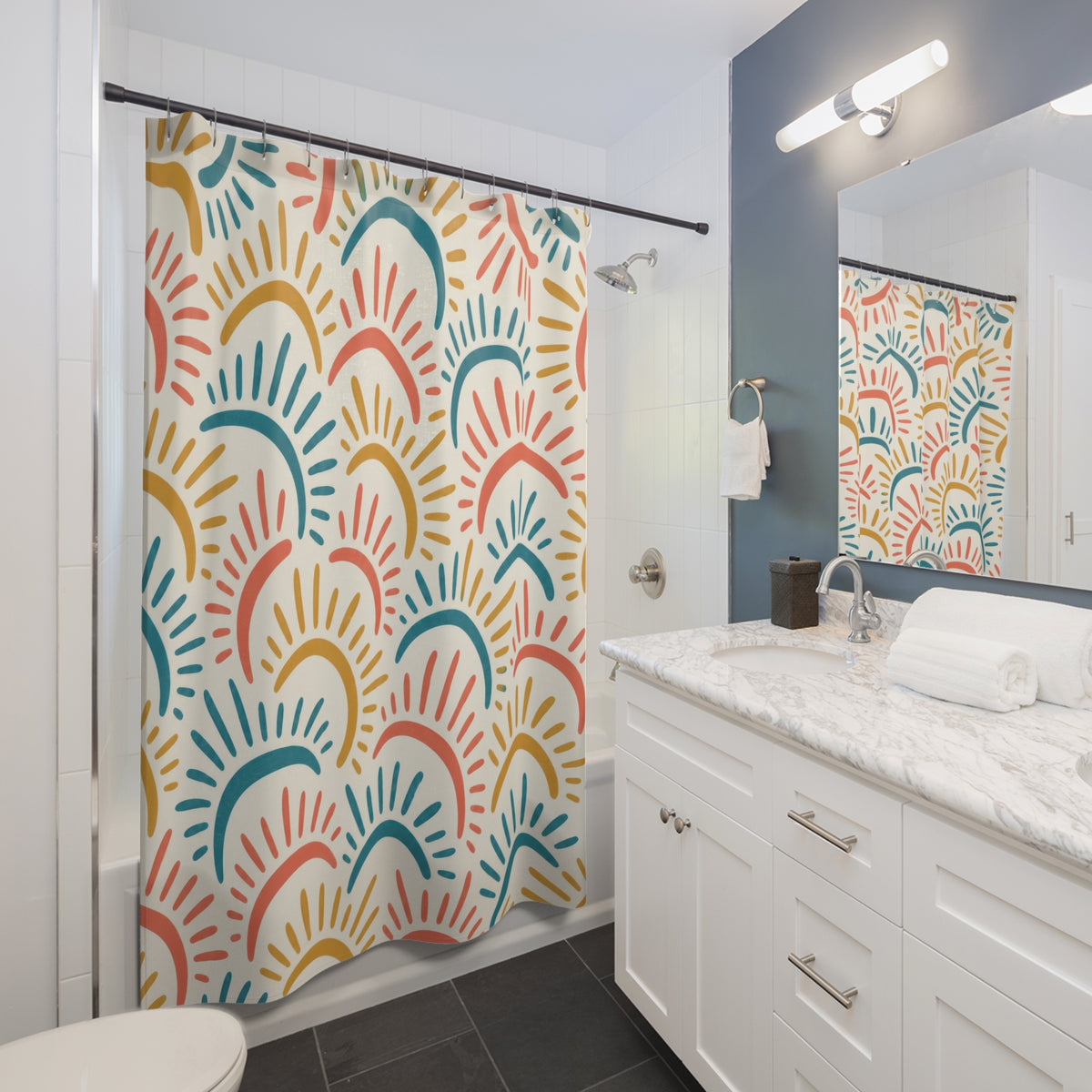 Coral, teal and ochre sun arcs with rays on ivory shower curtain beside a white vanity