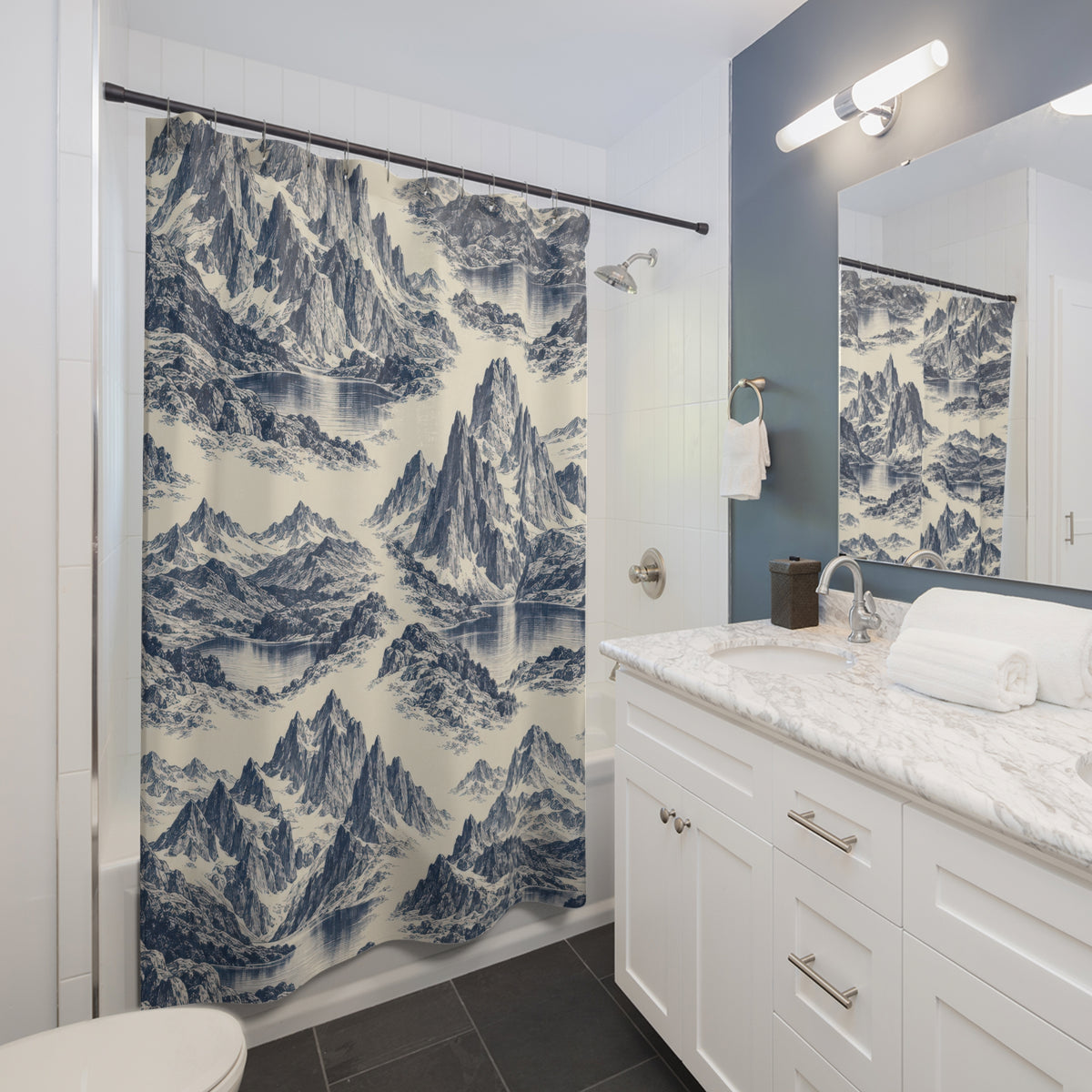 Indigo mountain and lake toile on ivory shower curtain beside a white vanity