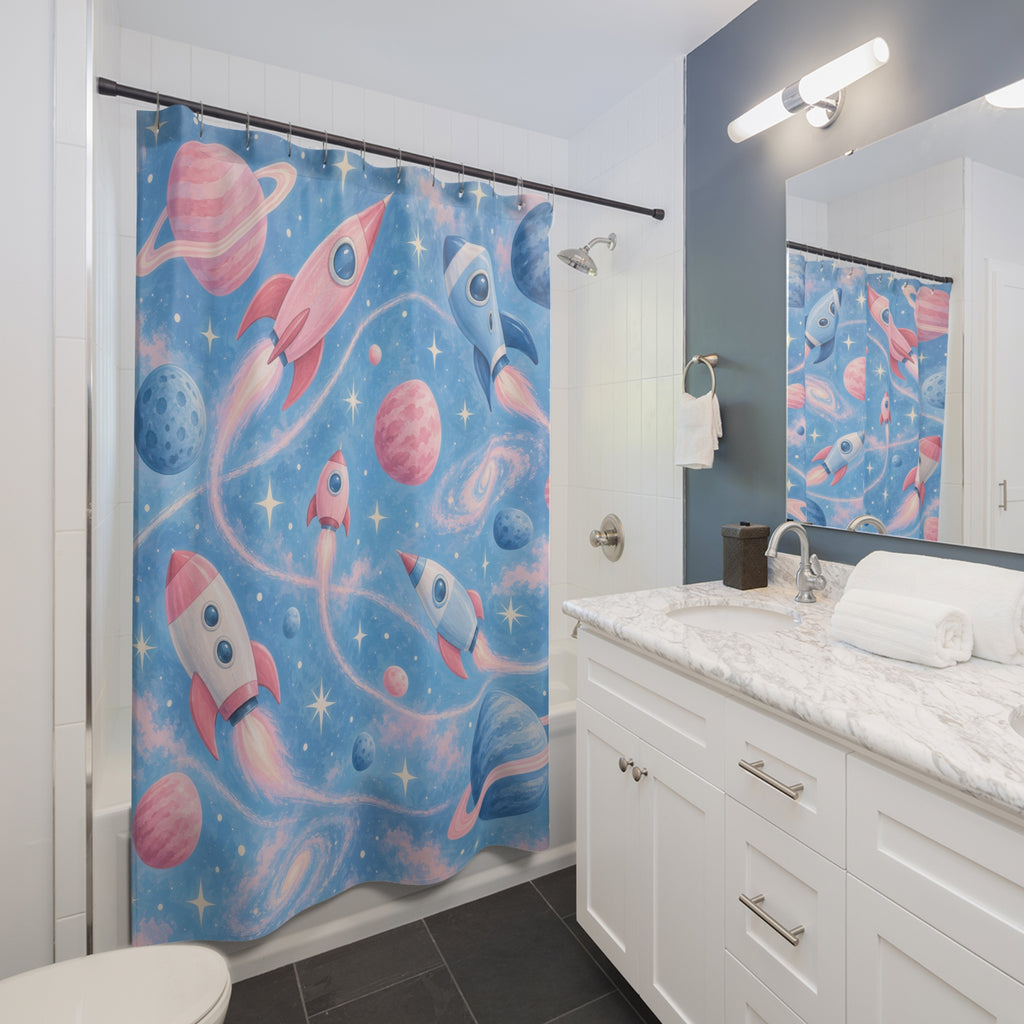 Pink and blue rockets and planets with ivory stars shower curtain beside a white vanity