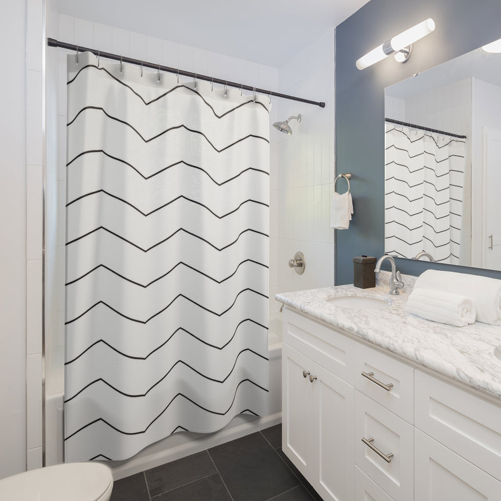 Fine black chevron rows on an open white ground shower curtain beside a white vanity