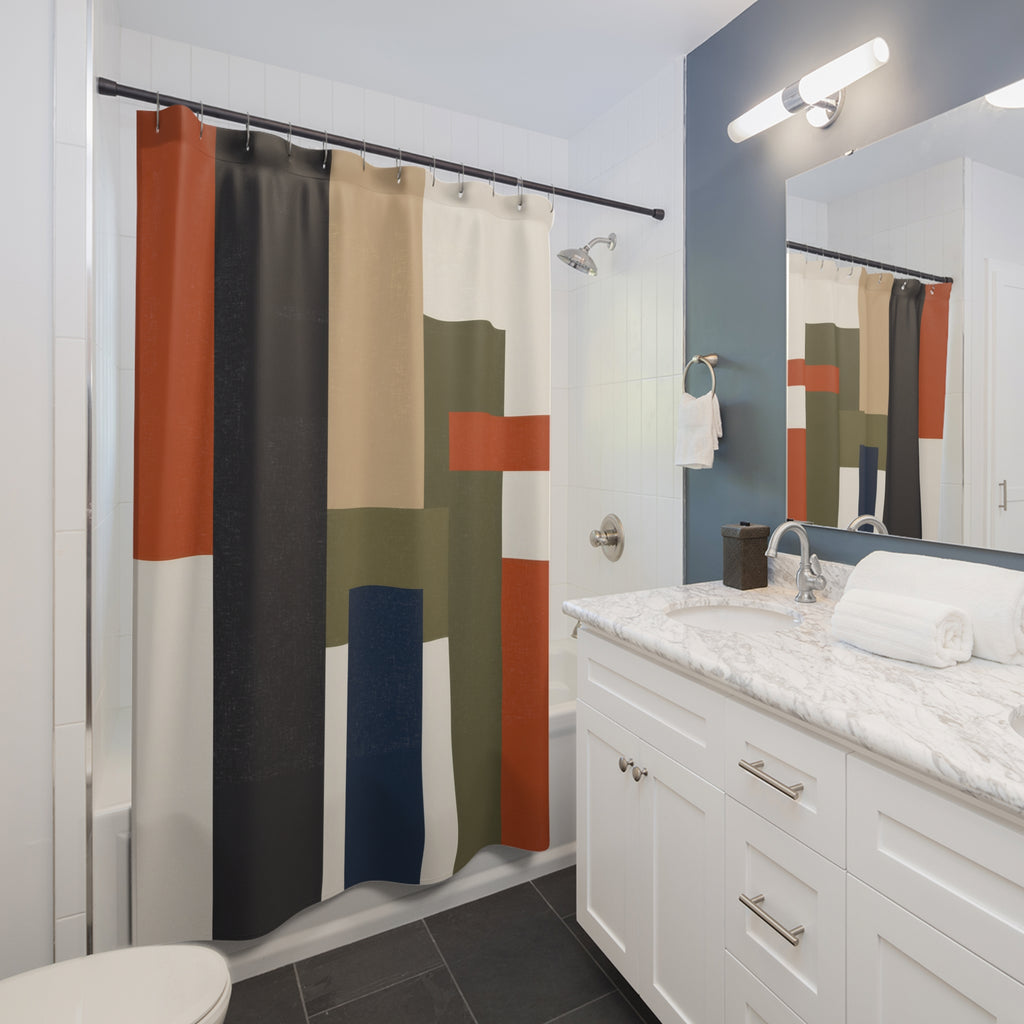 Charcoal rust and olive architectural blocks shower curtain beside a white vanity