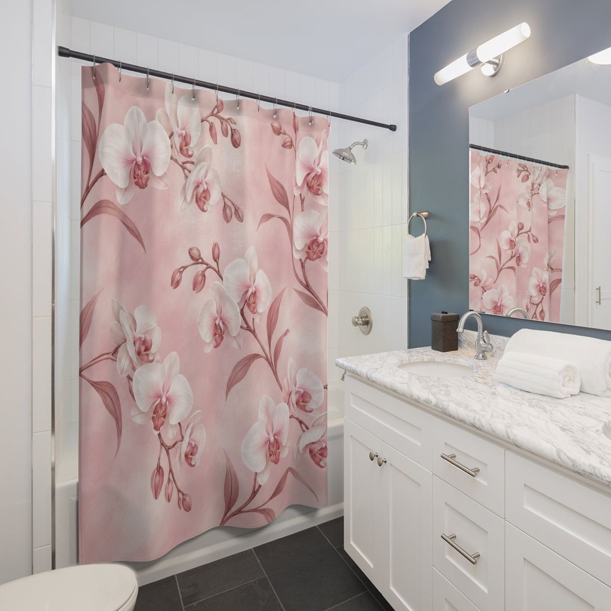 White orchids with rose stems on a blush ground shower curtain beside a white vanity