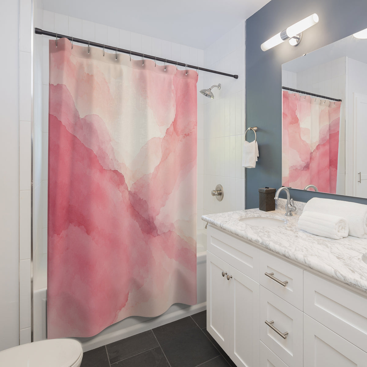Light pink watercolor washes with mauve edges shower curtain beside a white vanity
