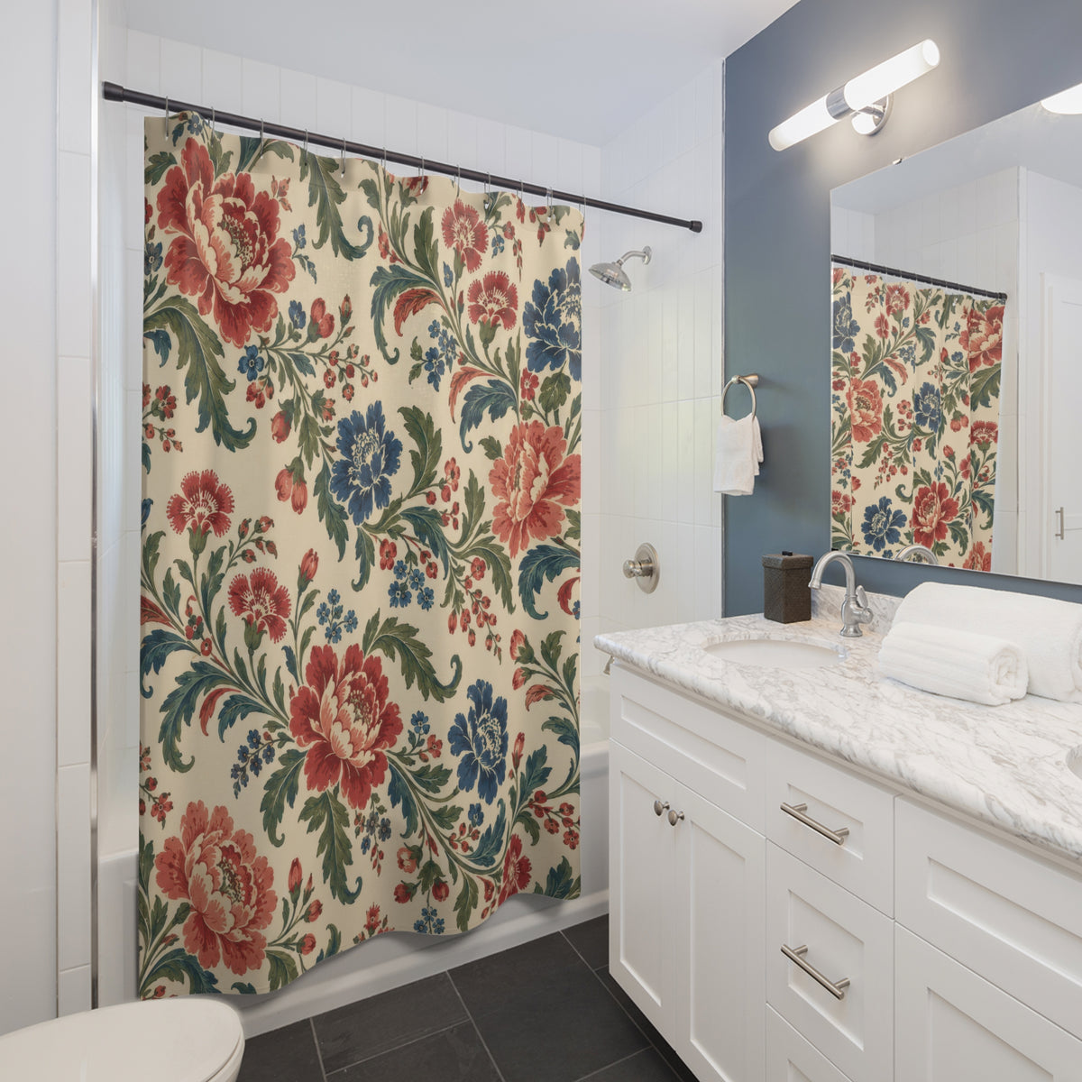 Red and blue chintz flowers with curling green leaves shower curtain beside a white vanity