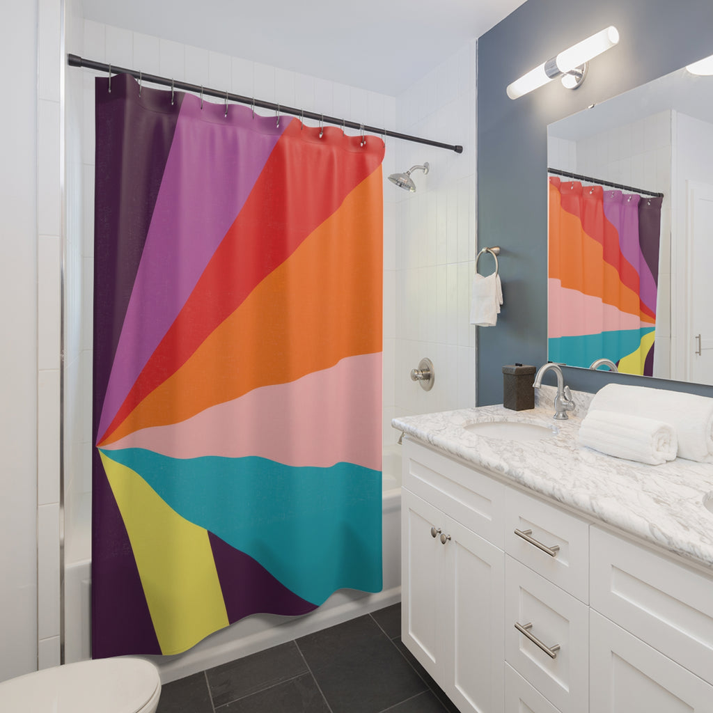 Plum orange and turquoise radial color panels shower curtain beside a white vanity