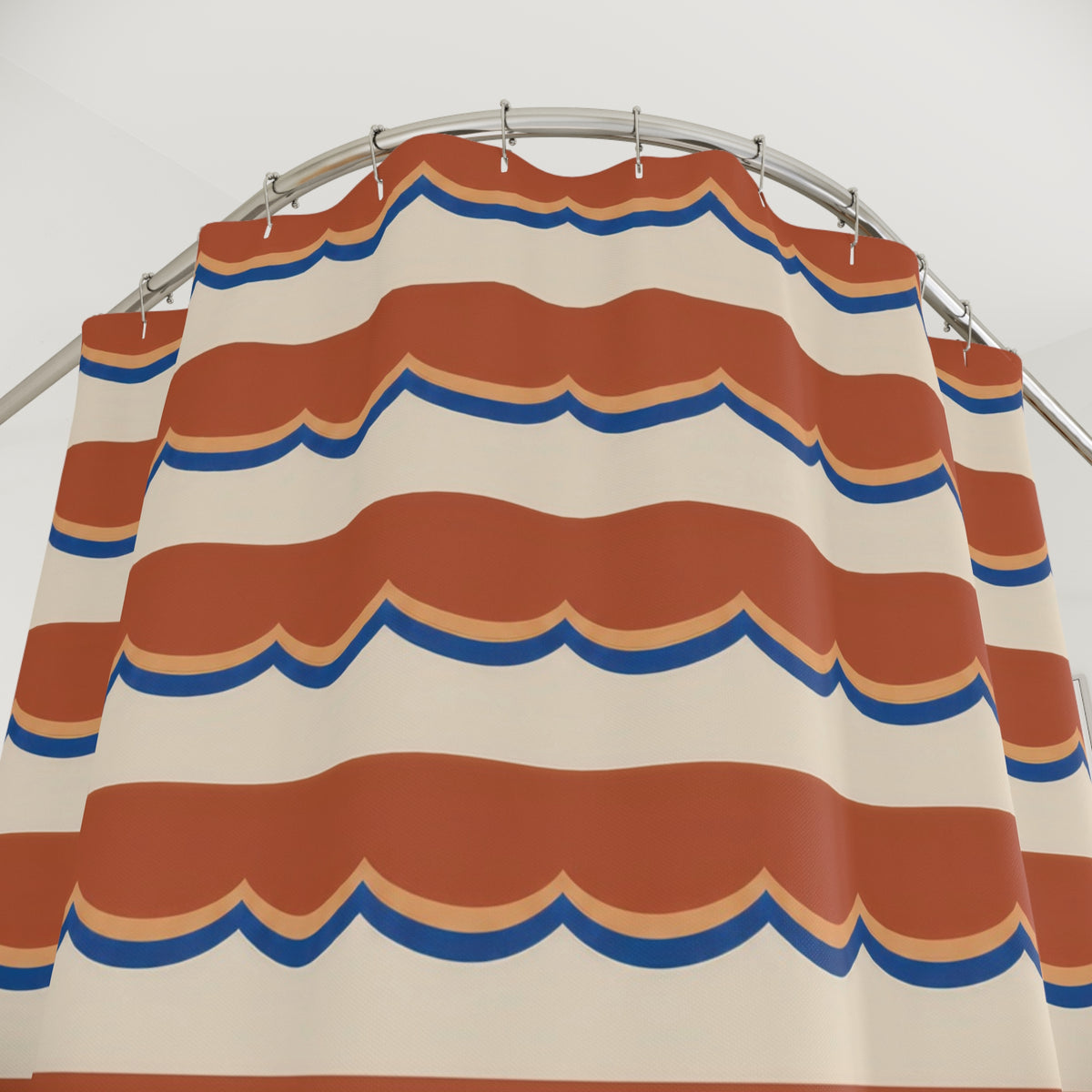 Terracotta scallop bands edged in apricot and blue on cream shower curtain with close-up print, hooks, and folds