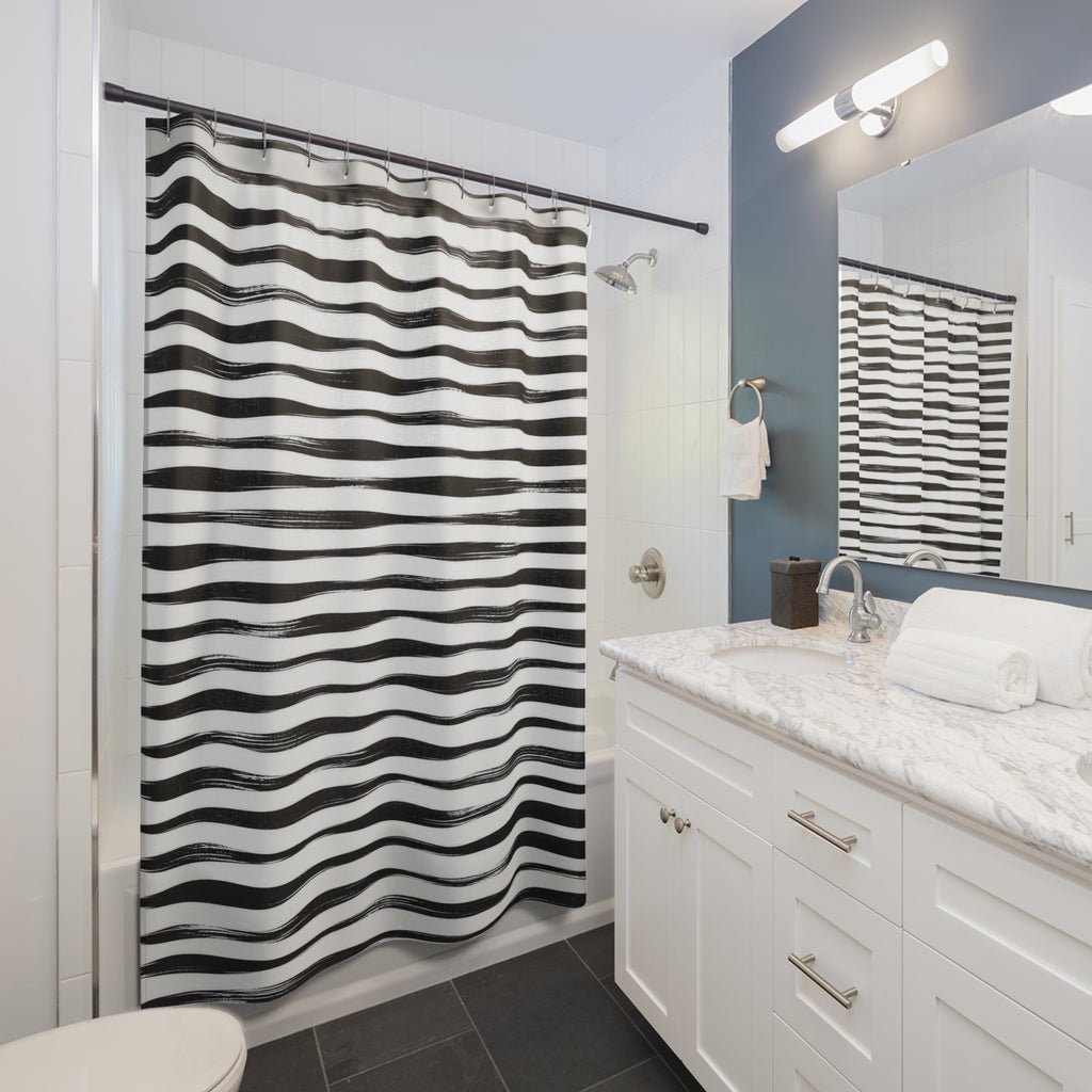 Horizontal black brush stripes with white dry-ink streaks shower curtain beside a white vanity