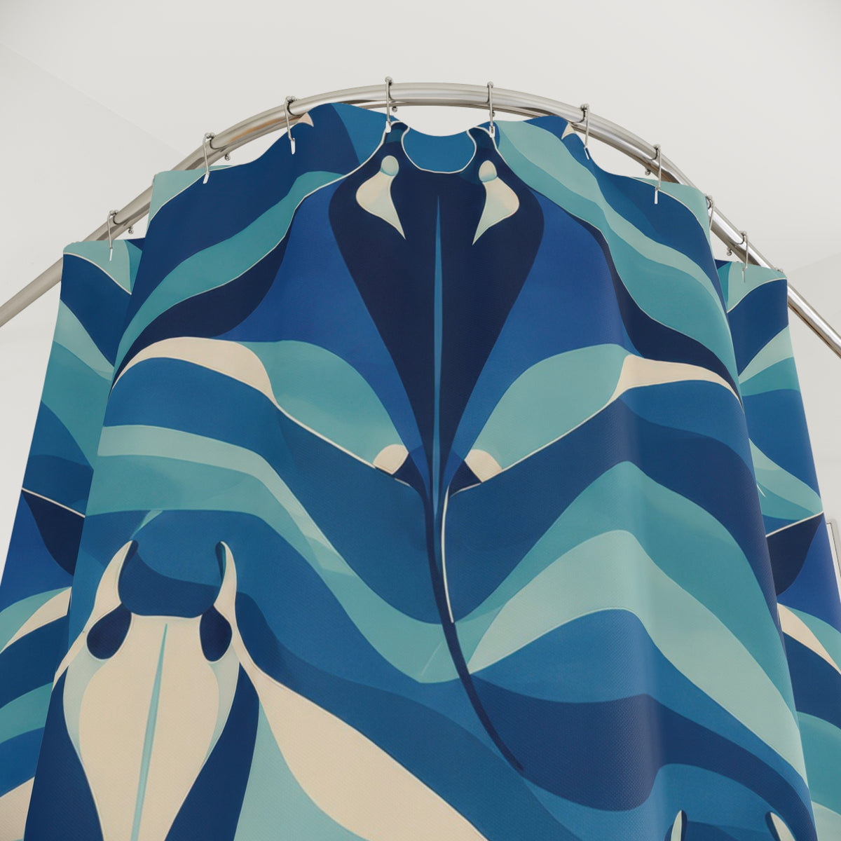 Navy and cream manta rays among blue and aqua wave bands shower curtain with close-up print, hooks, and folds