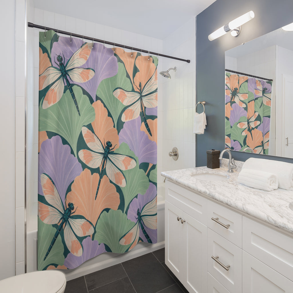 Pastel ginkgo leaves and teal dragonflies shower curtain beside a white vanity