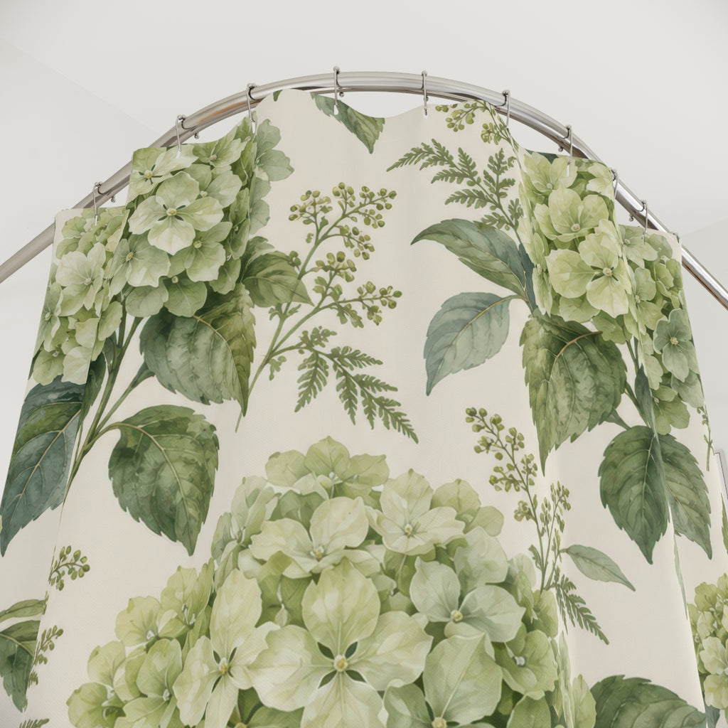 Sage-green hydrangea clusters and leaves on warm cream shower curtain with close-up print, hooks, and folds