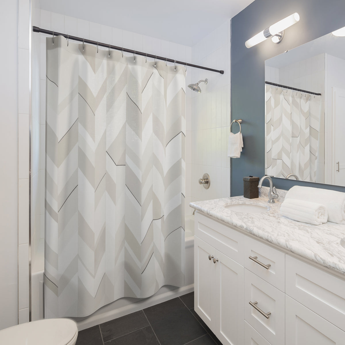 White and greige herringbone terraces with dark accents shower curtain beside a white vanity