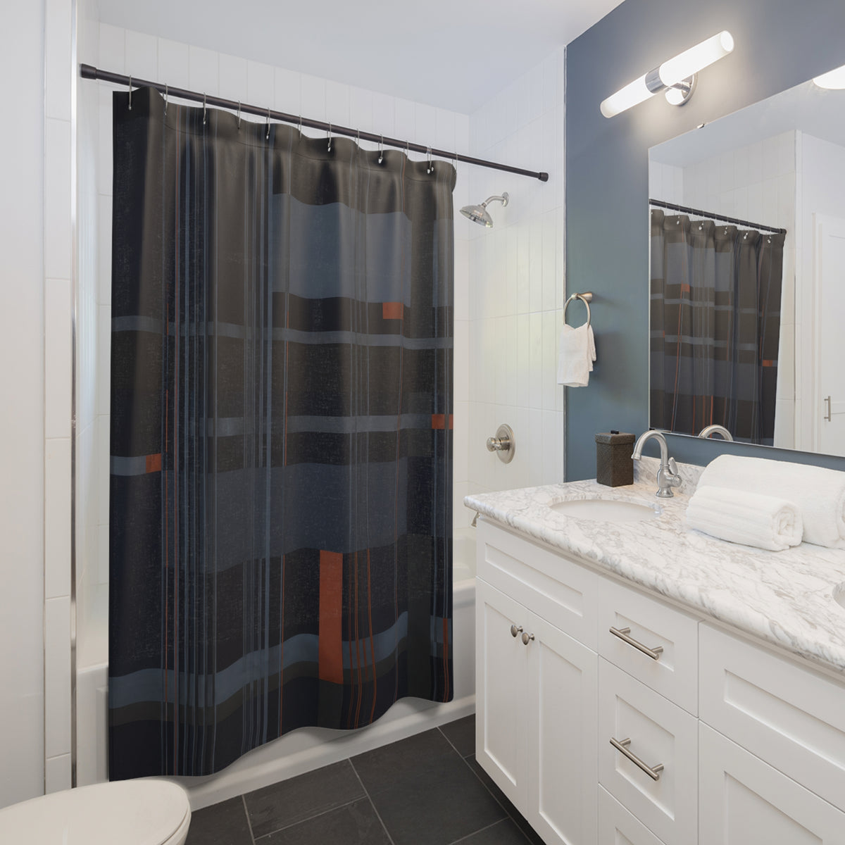 Navy pinstripes crossing slate plaid with rust accents shower curtain beside a white vanity