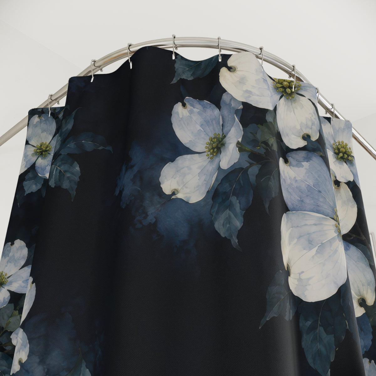 Pale blue and cream dogwood clusters on inky indigo shower curtain with close-up print, hooks, and folds
